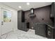 Stylish kitchen boasting dark cabinetry and marble floors at 641 Hamilton E Holmes Nw Dr, Atlanta, GA 30318
