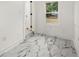 Clean laundry room with marble floors and a window at 641 Hamilton E Holmes Nw Dr, Atlanta, GA 30318