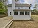 Exterior view with porch, stone steps and patio, and a large grassy lawn at 3549 Meadow Chase Dr, Marietta, GA 30062