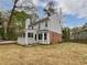 Back of the house with enclosed porch, lush lawn, and private backyard at 3549 Meadow Chase Dr, Marietta, GA 30062