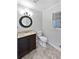 Bathroom featuring a dark wood vanity and dark, round mirror at 3549 Meadow Chase Dr, Marietta, GA 30062