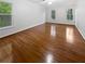 Bright bedroom with hardwood floors, two windows, white walls, and a ceiling fan at 3549 Meadow Chase Dr, Marietta, GA 30062