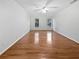 Bright bedroom with hardwood floors, two windows, white walls, and a ceiling fan at 3549 Meadow Chase Dr, Marietta, GA 30062