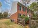 Two-story brick home with shuttered windows, and a lush lawn, complemented by mature trees at 3549 Meadow Chase Dr, Marietta, GA 30062
