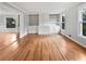 Open-concept living room featuring gleaming hardwood floors and built-in shelving for stylish storage at 3549 Meadow Chase Dr, Marietta, GA 30062