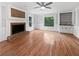 Spacious living room with hardwood floors, a cozy brick fireplace and stylish built-in shelving at 3549 Meadow Chase Dr, Marietta, GA 30062