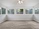 Bright sunroom with neutral carpet, white trim and large windows providing ample natural light at 3549 Meadow Chase Dr, Marietta, GA 30062