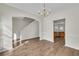 An elegant dining room featuring wood-look floors and an arched entryway to the kitchen at 621 Kenridge Way # 0, Suwanee, GA 30024