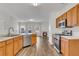 Modern kitchen with stainless steel appliances, wood cabinets, and a view to the living room fireplace at 621 Kenridge Way # 0, Suwanee, GA 30024