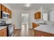 Functional kitchen with wood cabinets, modern appliances, and sightlines to the dining area at 621 Kenridge Way # 0, Suwanee, GA 30024