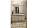 Bathroom features a large mirror, granite counters, and tiled floors at 115 Bond Dr, Ellenwood, GA 30294
