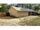View of house exterior showcasing back of home, concrete patio and fenced yard at 115 Bond Dr, Ellenwood, GA 30294