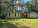 Charming single-story home with a well-manicured lawn and attached two-car garage at 115 Bond Dr, Ellenwood, GA 30294