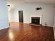 Bright living room with hardwood floors and a brick fireplace at 115 Bond Dr, Ellenwood, GA 30294