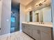 Elegant bathroom with double vanity, large mirror, and frameless shower at 700 Banton Nw Dr, Atlanta, GA 30318