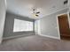 Bright bedroom with carpeted floors, ceiling fan, and large window at 700 Banton Nw Dr, Atlanta, GA 30318