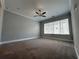 Spacious bedroom with carpeted floors, ceiling fan and large window at 700 Banton Nw Dr, Atlanta, GA 30318