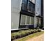 Modern two-story townhome with gray siding, balcony, and landscaped grounds at 700 Banton Nw Dr, Atlanta, GA 30318