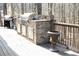 Backyard outdoor kitchen area with built in grill and cooking space on a wood deck at 86 Waterford Path, Hiram, GA 30141