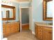 Spacious bathroom featuring double vanity sinks, tile floors, and stylish decor at 86 Waterford Path, Hiram, GA 30141