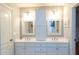 Spacious bathroom featuring a double vanity, framed mirrors, and bright lighting at 86 Waterford Path, Hiram, GA 30141