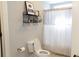 Bright bathroom features a toilet and a shower with a white shower curtain at 86 Waterford Path, Hiram, GA 30141