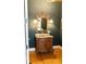 Luxurious bathroom with a wood vanity, marble countertop, and ornate mirror and sconces at 86 Waterford Path, Hiram, GA 30141
