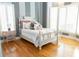 Cozy bedroom with hardwood floors, striped walls, and bright natural light at 86 Waterford Path, Hiram, GA 30141