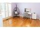 Cozy bedroom with hardwood floors, hanging chair, makeup vanity, and natural light at 86 Waterford Path, Hiram, GA 30141