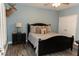 Comfortable bedroom with a black bed frame, grey walls, and a mounted deer head above the bed at 86 Waterford Path, Hiram, GA 30141