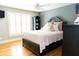 Inviting bedroom with hardwood floors, natural light, and a comfortable bed at 86 Waterford Path, Hiram, GA 30141
