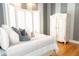 Bright bedroom with hardwood floors, striped accent wall, and decorative armoire at 86 Waterford Path, Hiram, GA 30141