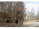 Stone-clad entrance to a wooded community with a black post sign and winding road at 86 Waterford Path, Hiram, GA 30141