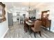 Dining area with a wooden table, chairs, and a view of the modern kitchen at 86 Waterford Path, Hiram, GA 30141