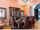 Well-appointed dining room with dark wood furniture, cabinet, and ornate decor accents for a luxurious feel at 86 Waterford Path, Hiram, GA 30141