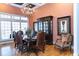Elegant dining room with a dark wood table and leather chairs, illuminated by a decorative chandelier at 86 Waterford Path, Hiram, GA 30141