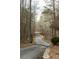 Long, winding driveway lined with mature trees, leading to a private and secluded property at 86 Waterford Path, Hiram, GA 30141