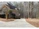 Suburban home exterior featuring a long driveway leading to the side-entry garage at 86 Waterford Path, Hiram, GA 30141