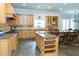 Well-appointed kitchen with a large island, wood cabinetry, and stone tile flooring at 86 Waterford Path, Hiram, GA 30141