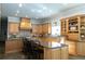 Spacious kitchen boasting wood cabinets, granite countertops, and a breakfast bar at 86 Waterford Path, Hiram, GA 30141