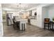 Modern kitchen featuring white cabinets, stainless steel appliances, a center island, and hardwood floors at 86 Waterford Path, Hiram, GA 30141