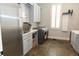 Bright laundry room with stainless steel appliances, gray cabinets and countertop space at 86 Waterford Path, Hiram, GA 30141