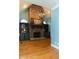 Cozy living room features a stone fireplace, hardwood floors, and built-in shelving at 86 Waterford Path, Hiram, GA 30141