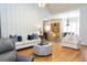 Cozy living room showcasing hardwood floors, white sofas with blue pillows, and open access to the kitchen at 86 Waterford Path, Hiram, GA 30141