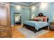 Bright and cozy main bedroom with hardwood floors, ensuite bathroom, and decorative furniture at 86 Waterford Path, Hiram, GA 30141