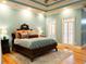 Inviting bedroom with aqua walls, decorative rug, and a comfortable bed with plush pillows and shuttered windows at 86 Waterford Path, Hiram, GA 30141