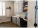 Home office with gray built-in shelving, cabinets, desk, and a window for natural light at 86 Waterford Path, Hiram, GA 30141