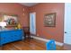 Home office with hardwood floors, colorful decor, a blue desk, and natural light at 86 Waterford Path, Hiram, GA 30141