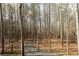 Wooded lot featuring natural surroundings with a long winding gravel driveway path at 86 Waterford Path, Hiram, GA 30141