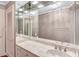 Bright bathroom with white cabinets, marble countertop, modern fixtures, and large mirror at 3649 Peachtree Ne Rd # 201, Atlanta, GA 30319